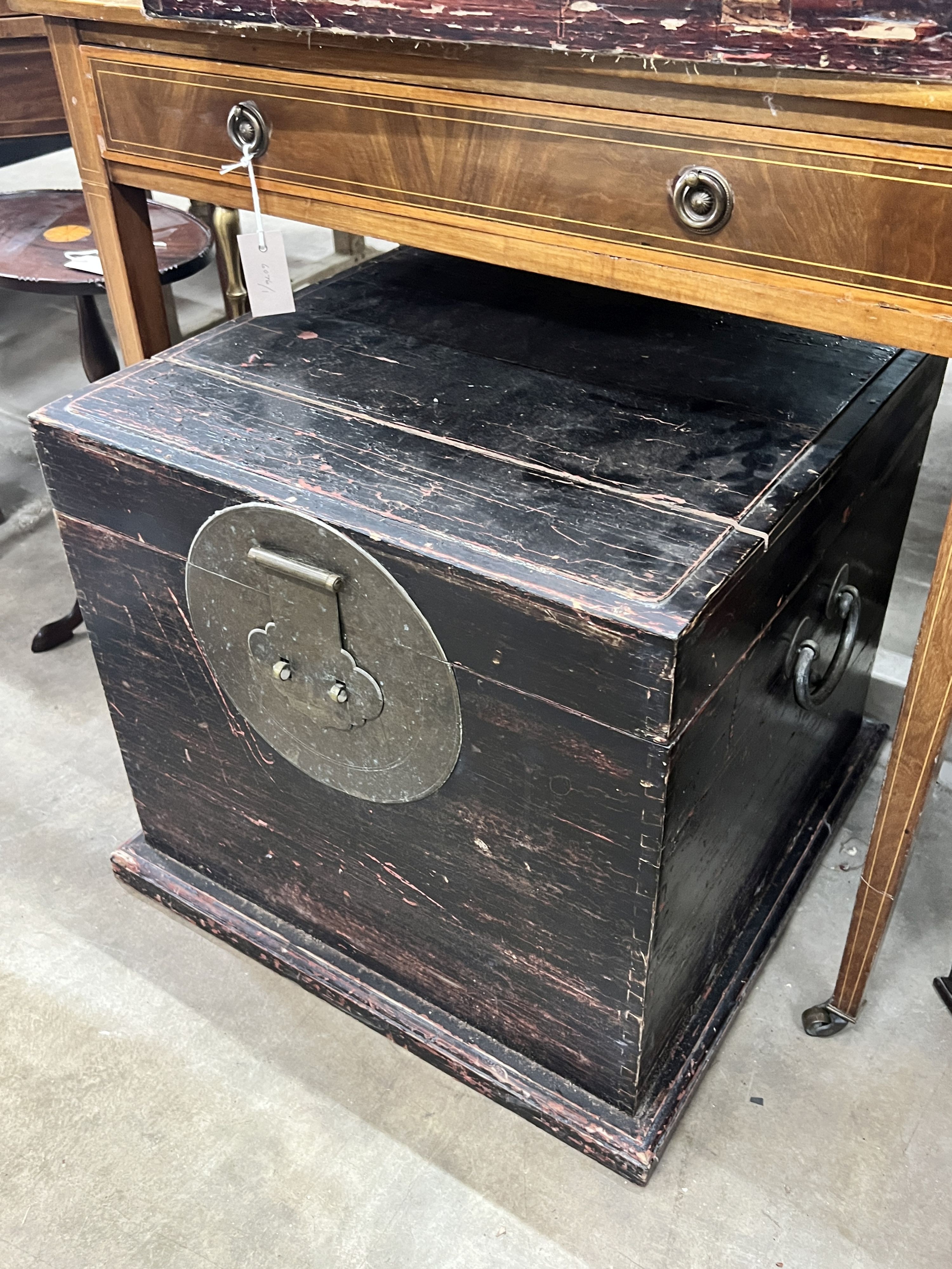 A Chinese lacquered trunk, width 55cm, depth 54cm, height 54cm